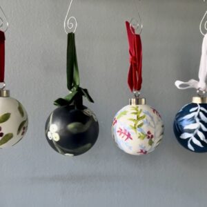4 ornaments of different patterns hang next to eachother