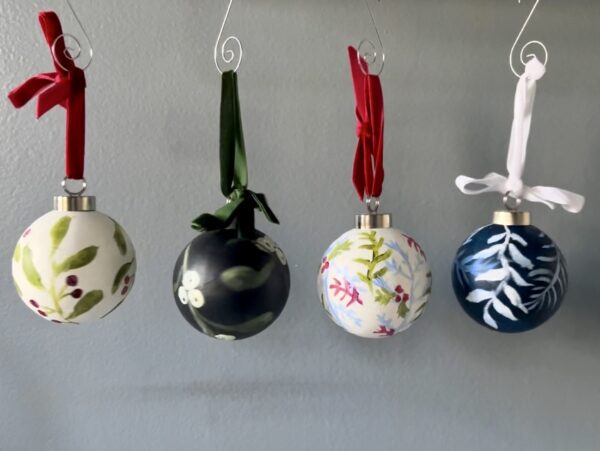 4 ornaments of different patterns hang next to eachother